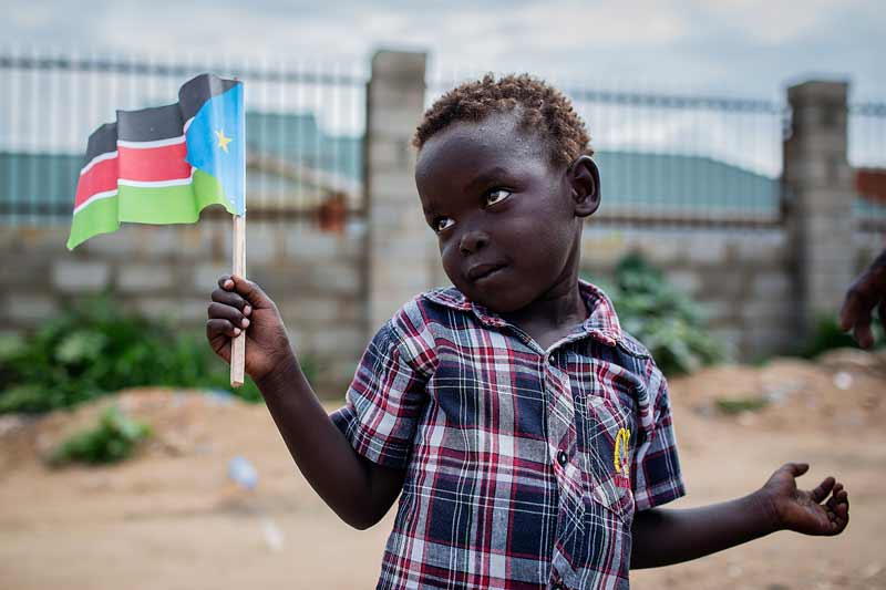 Three-year-old boy holding South Sudan flag