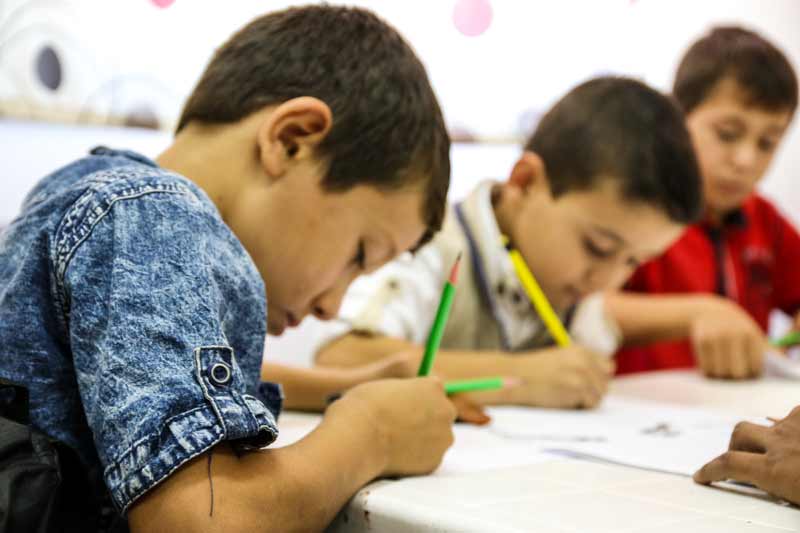 Syrian and Jordanian children working on their studies