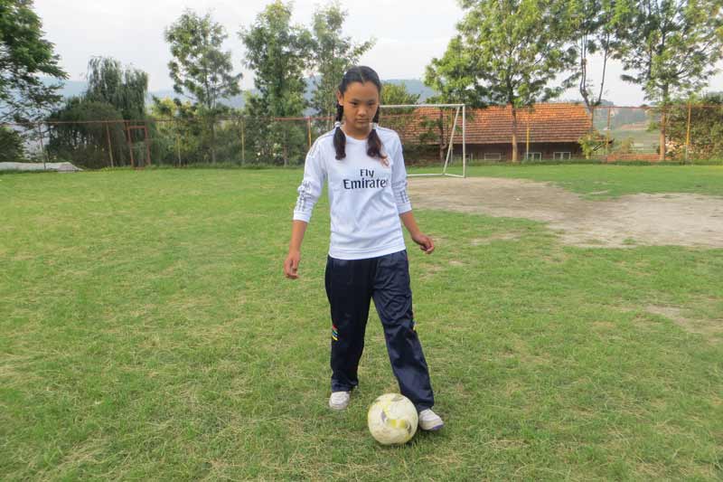 Girl playing soccer in Nepal