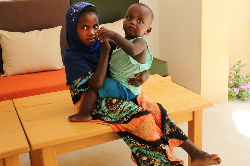 Rara holding her SOS brother in - Tadjourah, Djibouti