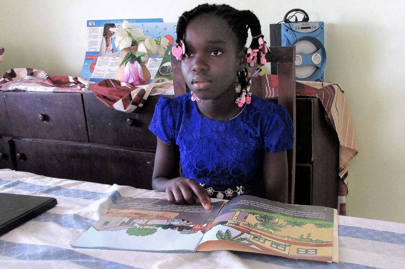 SOS child working on her homework in Côte d’Ivoire