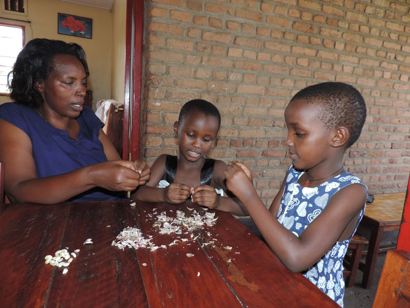 SOS mother and children peeling garlic for agatoke