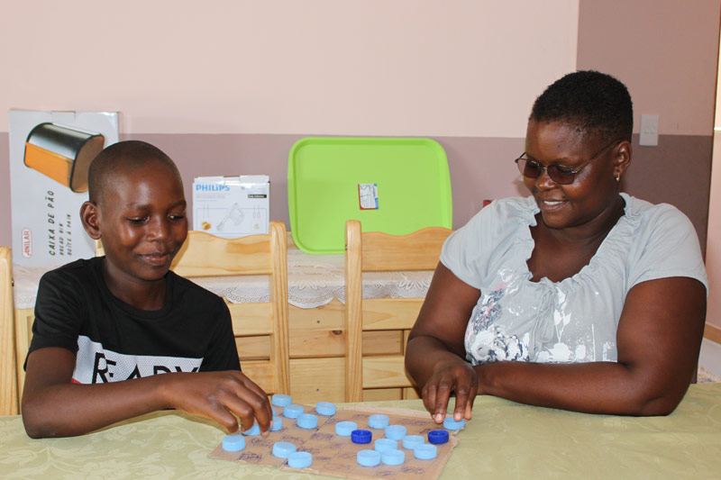 SOS mother Zelia playing a game with her son Edricio
