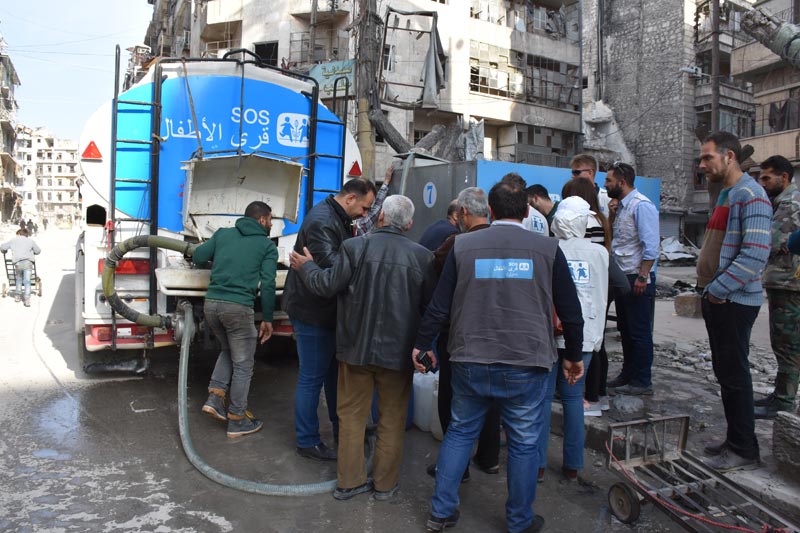 SOS water truck distributin water to residents of Aleppo, Syria