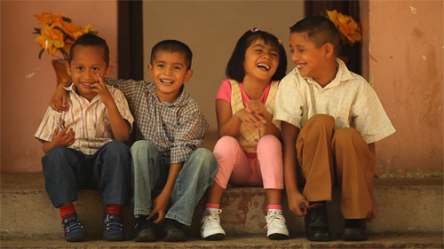 4 SOS Sponsored Smiling Children Sitting on Stoop