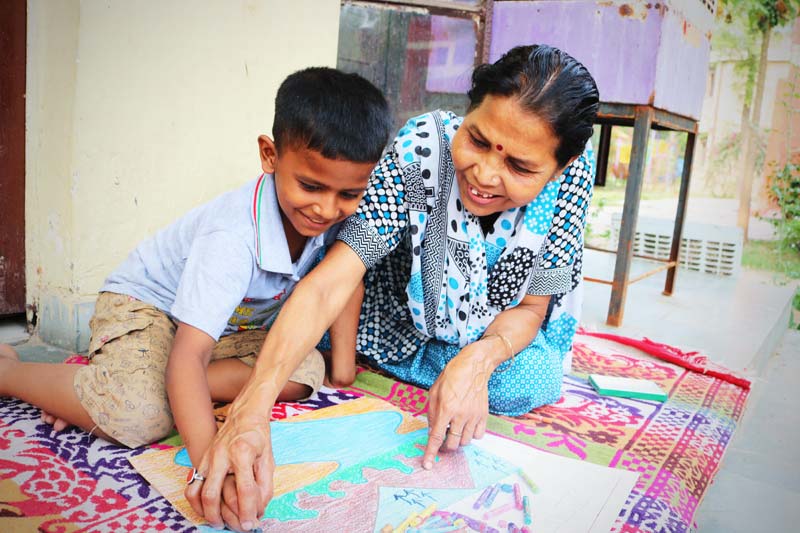 SOS mother and son looking at a painting