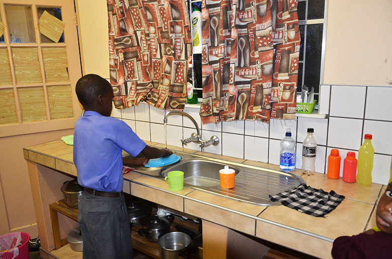 Boy doing the dishes