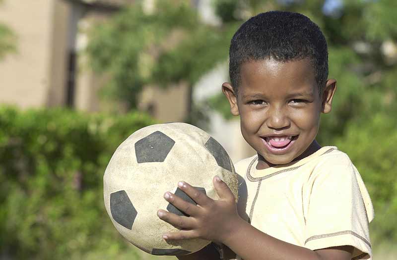 Sponsored boy holding soccer ball in Sudan