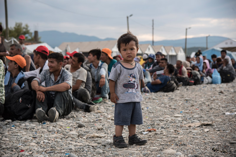 Child refugee waiting to move on in refugee camp in Serbia