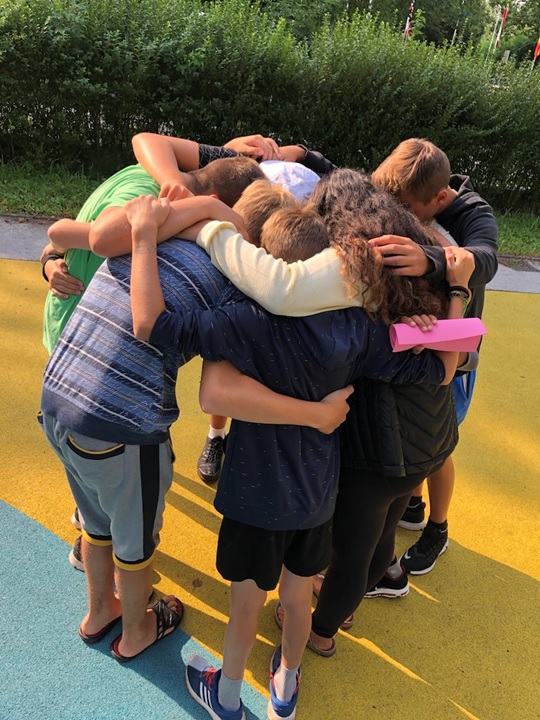 SOS kids hugging goodbye on the last day of camp.