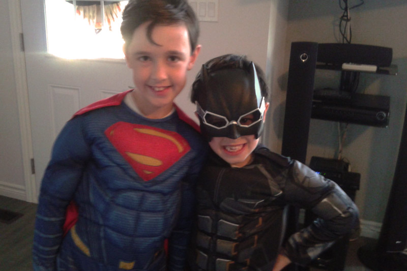 Two young boys in their superhero costumes