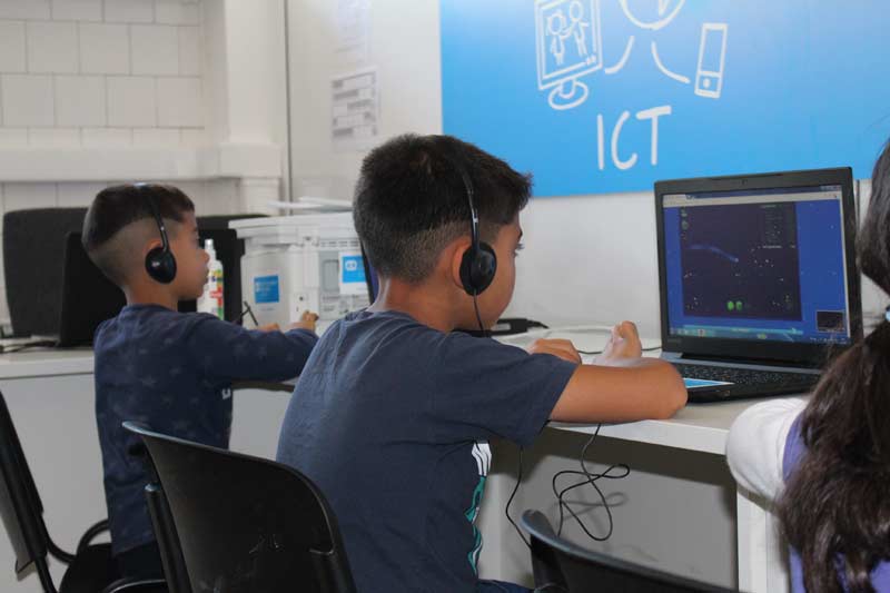 Two boys using the ICT Corner in Bujanovac.