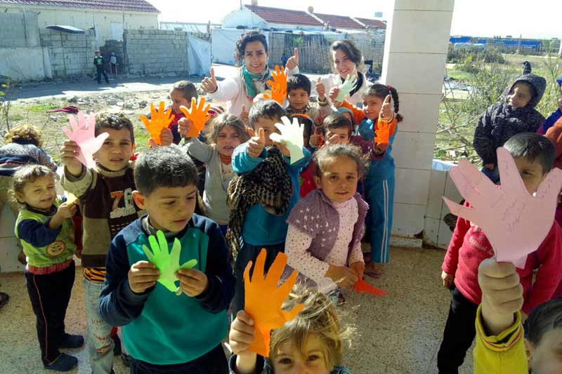 Children holding cutout hands