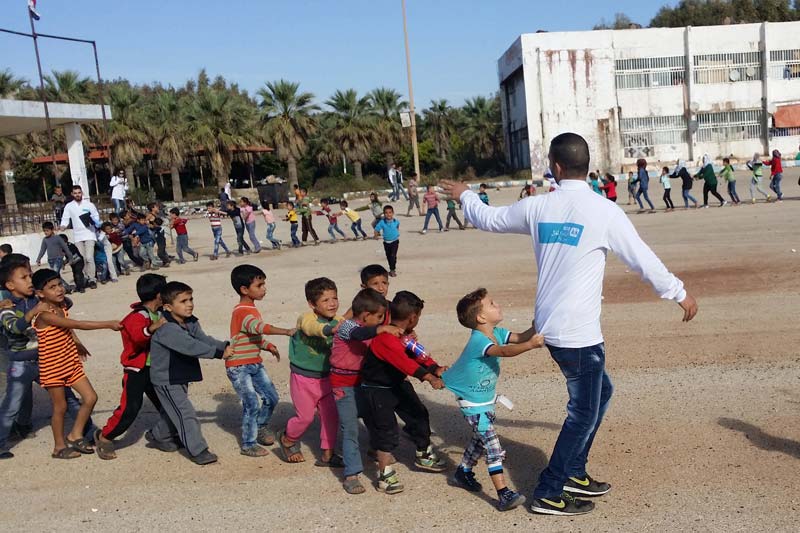 Children in a conga line in Damascus, Syria