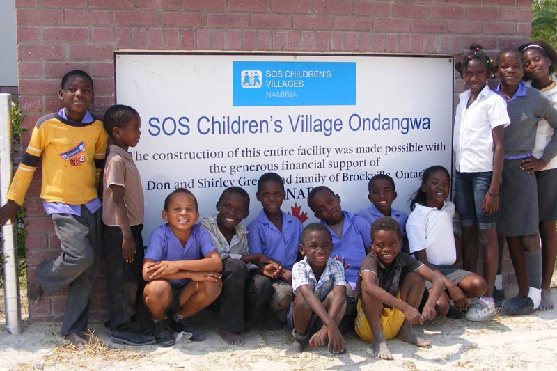 SOS Children's Village Ondangwa sign with children smiling