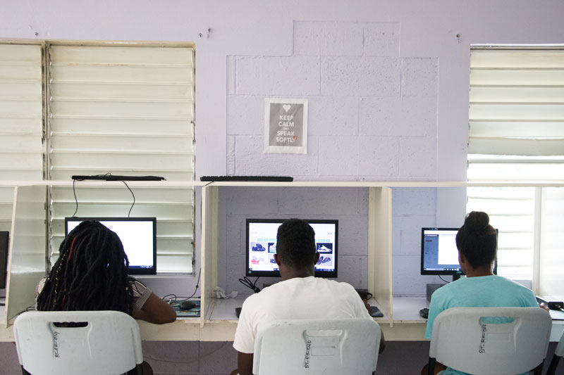 Children doing homework on computers in Jamaica