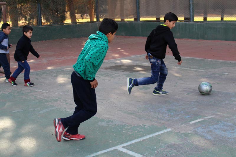 Children playing soccer in Saboura, Syria