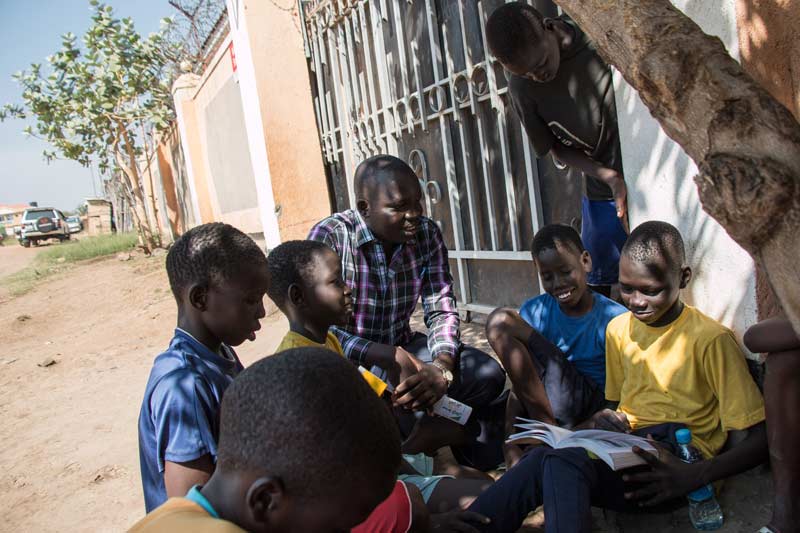 Children reading under tree