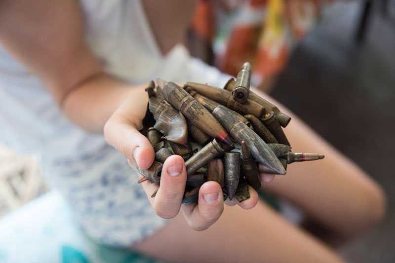 Chid's hand holding bullets in Stanytsia Luhanska, Eastern Ukraine