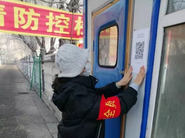 A worker posts a warning about the coronavirus at an SOS Village.