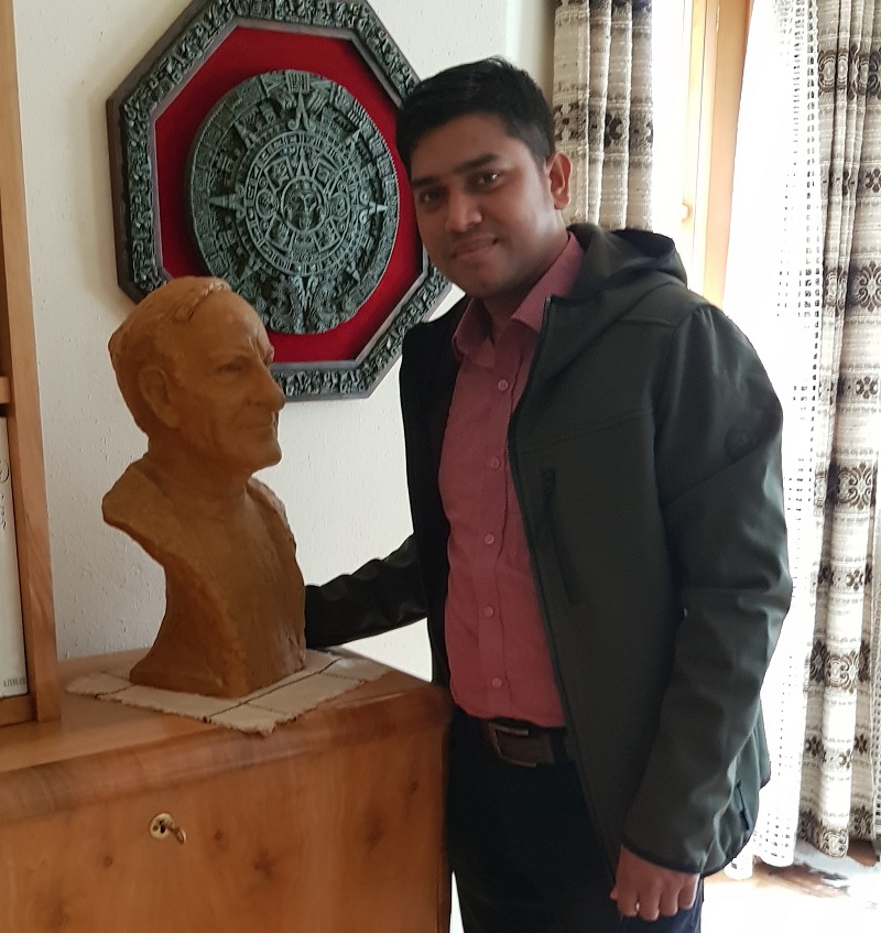 Dr. Arif posing with statue