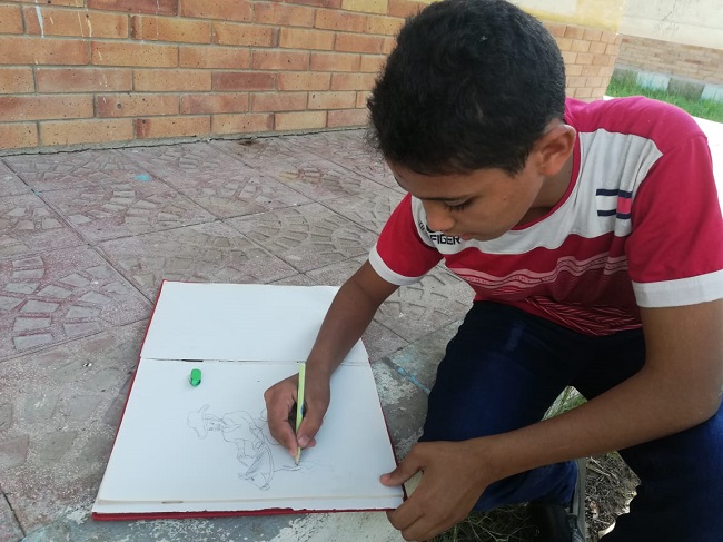 Samer working on another drawing.