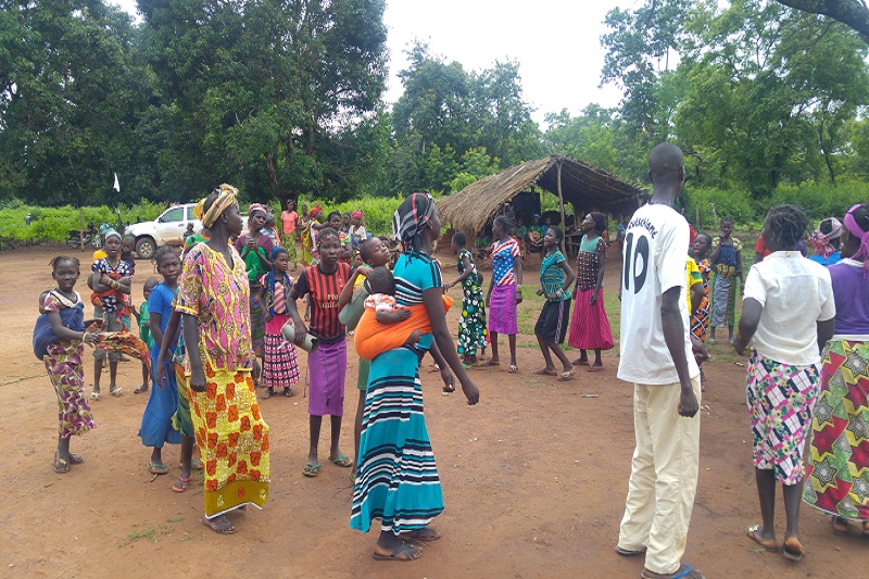 Villagers standing in line for assistance.