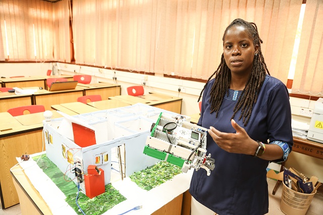 Mandy holding a students robotics creation.