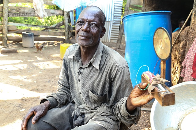 Nyaaba shows off the makeshift lamp his daughters use to complete their homework.