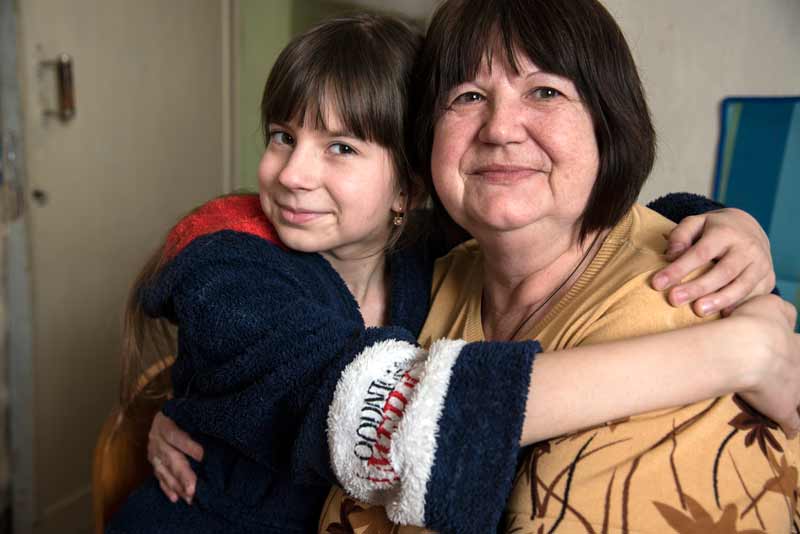 Mashenka and her grandmother embracing