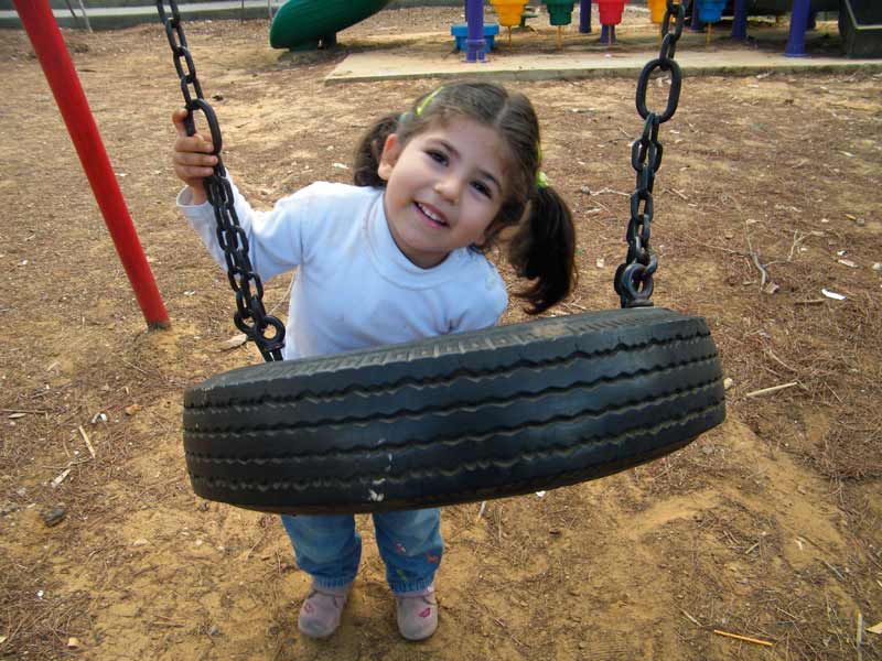 Sponsored girl playing on swing in Lebanon