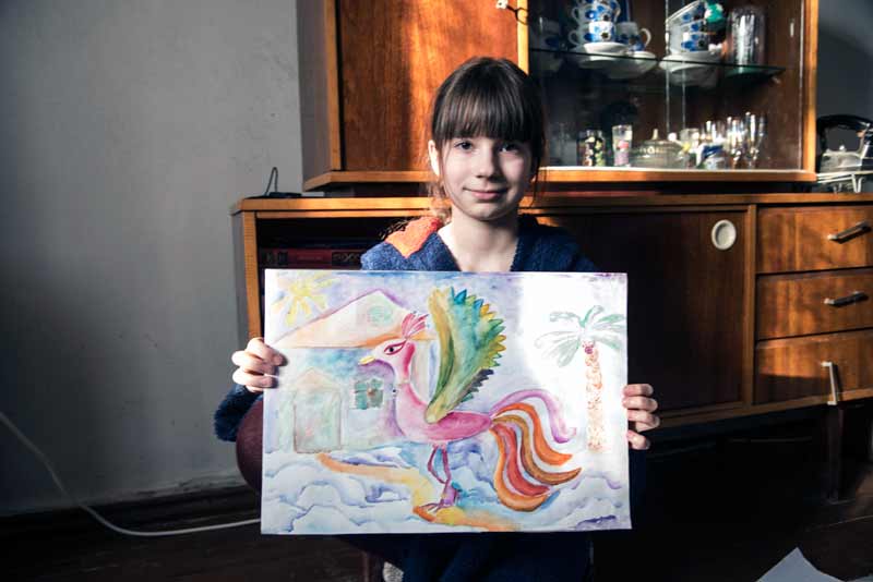 Mashenka proudly showing her painting