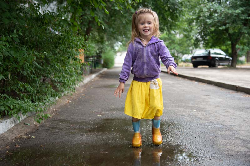 Girl standing in puddle in Ukraine