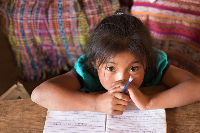 Girl with notebook, family strengthening program in Guatemala