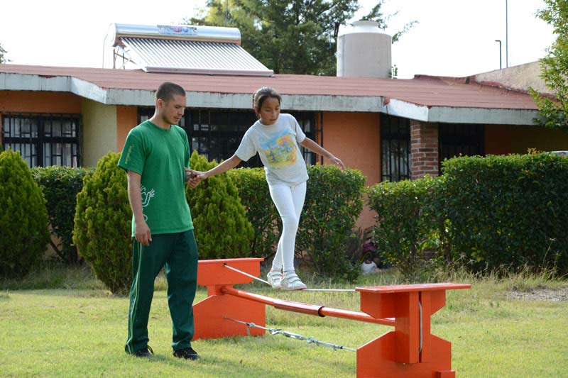 Girl walking on tightrope, SOS Social Circus