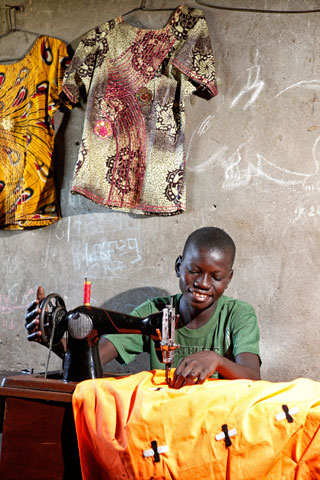 Kouloun boy sewing shirts