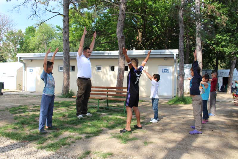 The kids need to be active. Cultural mediator Mahmoud ElShair keeps the boys busy with some exercises on the reception centre ground.