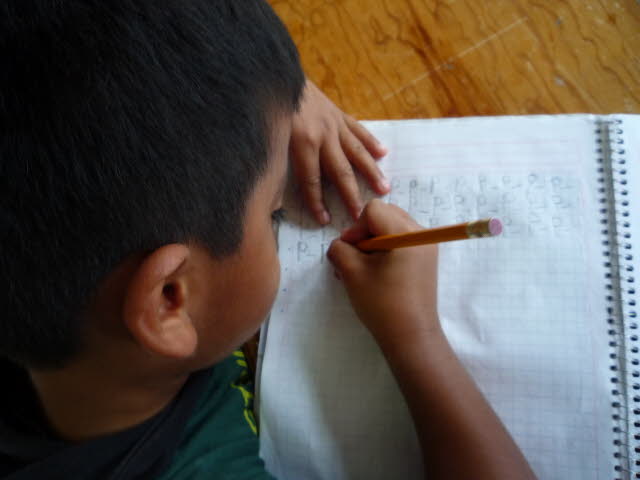 An SOS child working on his studies.