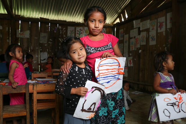 Two SOS girls showing off their artwork.