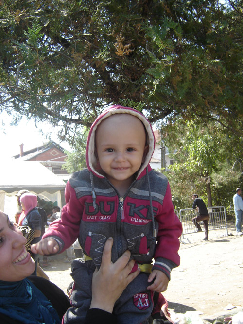 Mother holding her son in refugee camp in Serbia