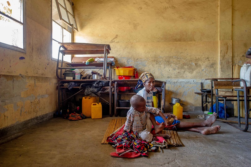 Woman and child in makeshift shelter