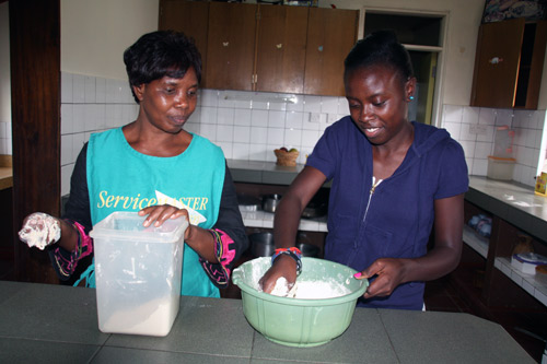 Neema cooking with her SOS Mother