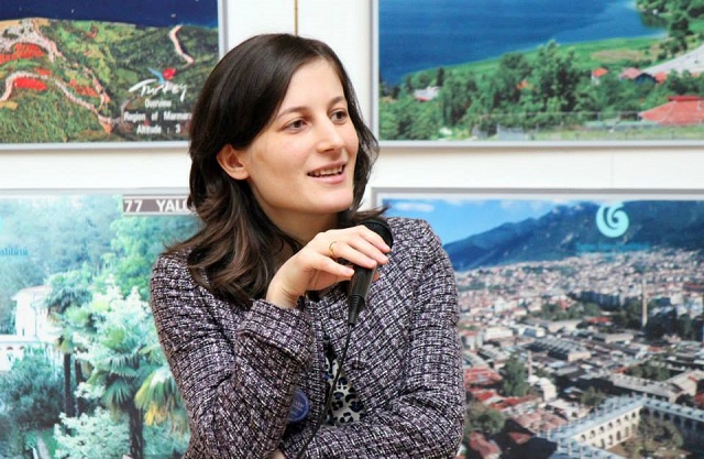 Nelly Akobia speaking during a presentation.