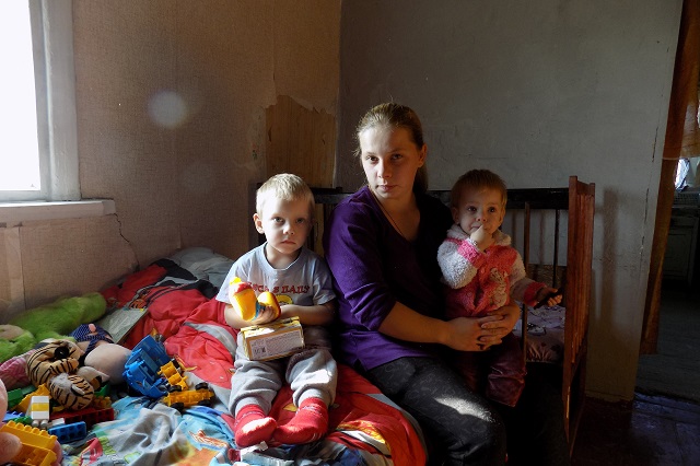 Anastasia with her children in a temporary shelter.