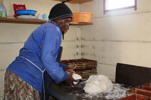 Wambi preparing a large ball of dough