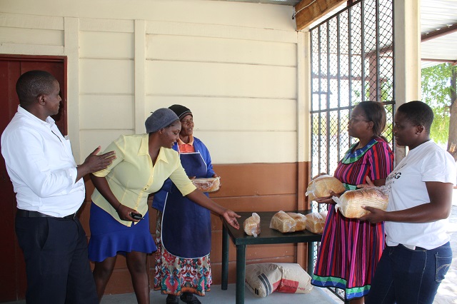 Sanna and Wambi selling bread to customers