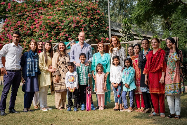 The Royal couple posing with staff and children from SOS Children's Villages Lahore.