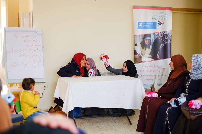 Mothers using puppets