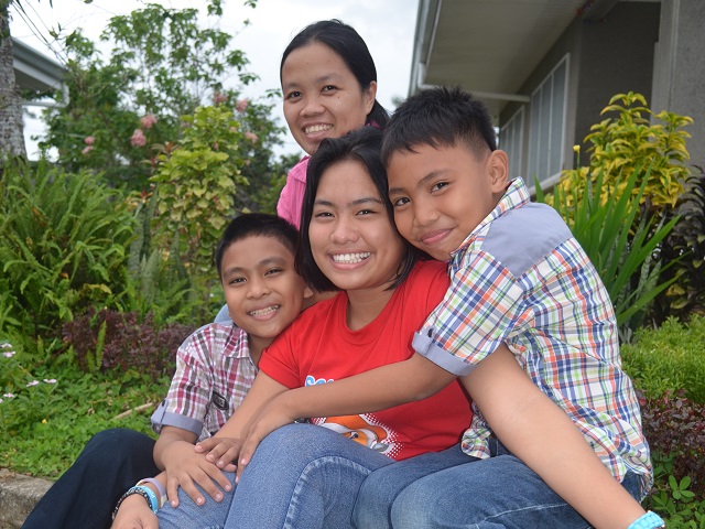 SOS Mother being hugged by her kids.