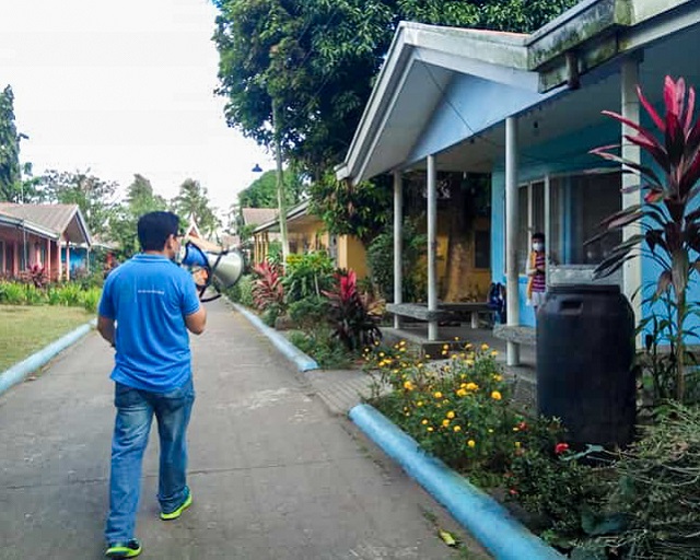 An SOS employee uses a megaphone in preparation of evacuations.